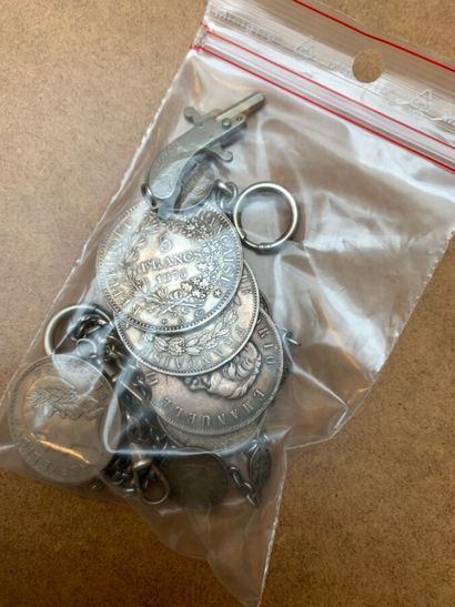 Set of silver coins, chain and small pistol,...