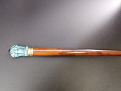 null Cane in natural wood decorated with a silver pommel with 18 k gold ring decorated...
