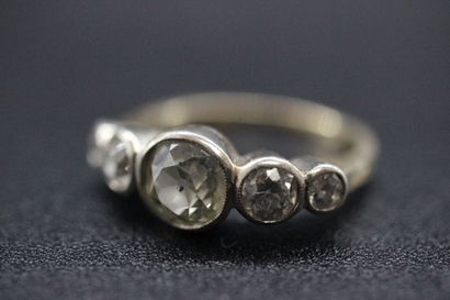 null Yellow and white gold ring set with 5 old cut diamonds, the central one about...