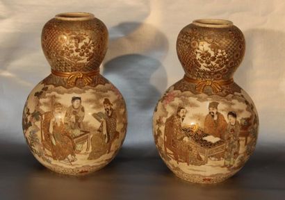 JAPON Paire de vases de forme coloquinte en faïence de satsuma à décor de personnages....