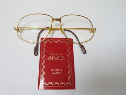 null CARTIER Paire de lunettes de vue pour homme, monture en plaqué or (usure aux...