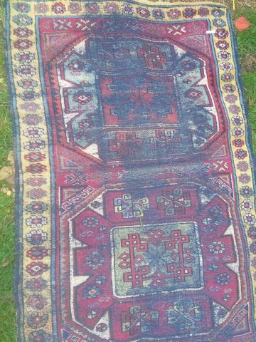 null EAST Hamedan wool rug with stylized plant motifs on a red background and yellow...