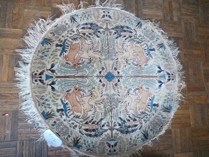 null Round silk dwarf carpet with animals on a beige background. 80 cm diameter.