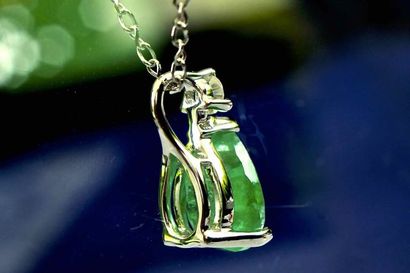 null 18 kt white gold necklace made of a laboratory certified pear cut natural Emerald...