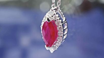 null Necklace in 18 kt white gold set with a certified natural marquise cut ruby...