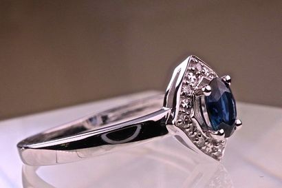 null Ring with an oval intense blue and transparent sapphire set with 0.45 carat...