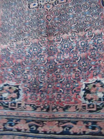null IRAN Ancien tapis Sarouk en laine, à décor végétal sur fond rose. 260 x 165...
