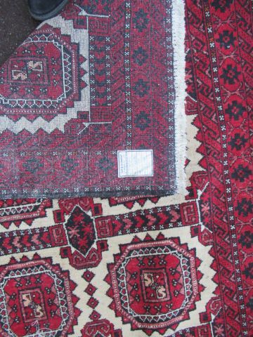 null AFGHANISTAN Ancien tapis Belloch, à décor géométrique sur fond rouge. 168 x...