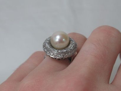 null 18K white gold coktail ring set with a cultured pearl and diamonds. French work....