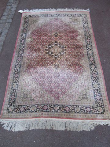 null Ferahan carpet in wool and silk, with vegetal decoration on a pink background....