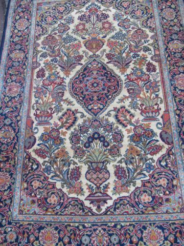 null Woolen Keshan carpet, decorated with a flowering vase on a blue and beige background....