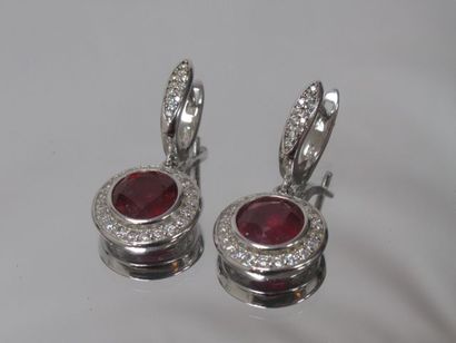 A pair of silver earrings set with rubies...