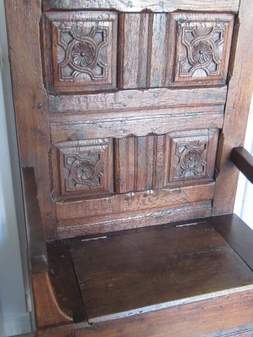 null Carved natural wood cathedra (or armchair), the back decorated with four medallions....