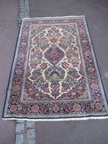 null Woolen Keshan carpet, decorated with a flowering vase on a blue and beige background....