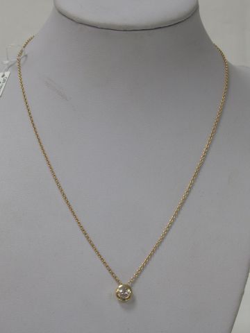 null Set in 18K yellow gold comprising a chain and its pendant set with a 0.50 ct...