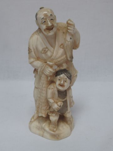 JAPAN Okimono in ivory, representing a fisherman...