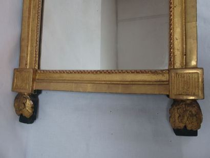null Wooden mirror and gilded stucco surmounted by a medallion topped by an enrubane,...