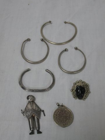 null Lot en métal argenté, comprenant 4 bracelets rigides, 3 broches mexicaines et...
