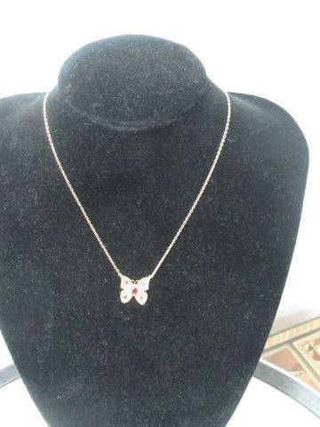 null Necklace in yellow gold 18 Kt decorated with a butterfly set with small rubies...