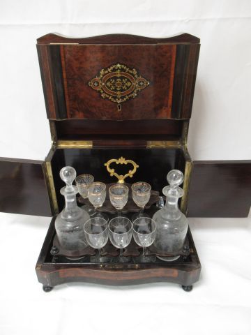 null Liqueur cabinet in veneer, lid decorated with a brass cartouche. It contains...