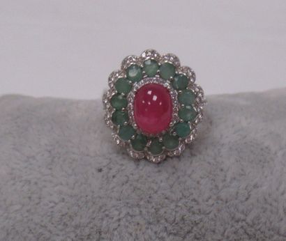 null Silver ring, centered on a cabochon ruby (2.10 carats) in a circle of emeralds....