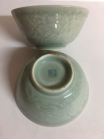null CHINA Pair of celadon ceramic bowls with relief decoration of fish swimming...