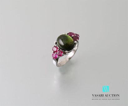 null White gold ring adorned with a cabochon green tourmaline calibrating 4.30 carats...