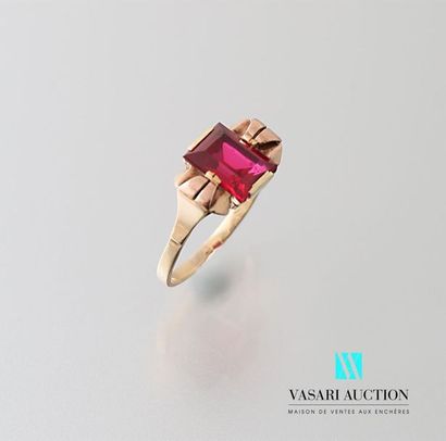 null Yellow gold ring adorned in its center with a synthetic emerald cut ruby framed...