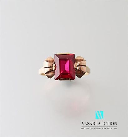 null Yellow gold ring adorned in its center with a synthetic emerald cut ruby framed...