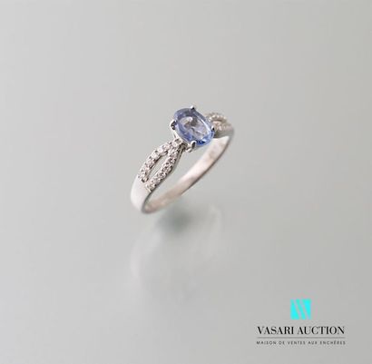 null White gold ring set in its center with an oval sapphire crystal calibrating...