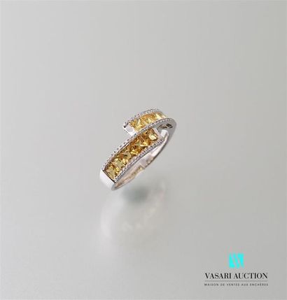 null White gold ring with a contraried body set with ten calibrated yellow sapphires...
