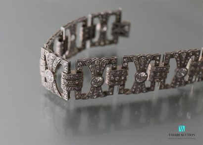 null Platinum bracelet, articulated with eight openwork quadrangular motifs featuring...