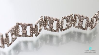 null Platinum bracelet, articulated with eight openwork quadrangular motifs featuring...