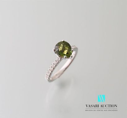 null White gold ring adorned with a green tourmaline pear-cut calibrating 1.68 carats,...