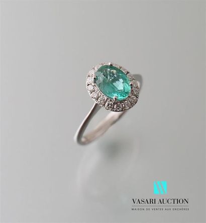 null White gold ring adorned with an oval cut emerald calibrating a carat in a modern...