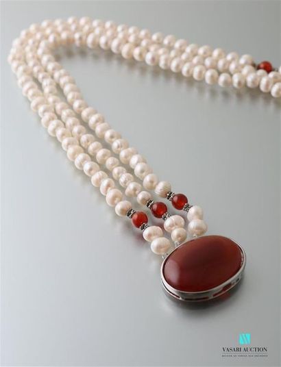 null Necklace three rows of freshwater cultured pearls, the red agate cabochon clasp,...
