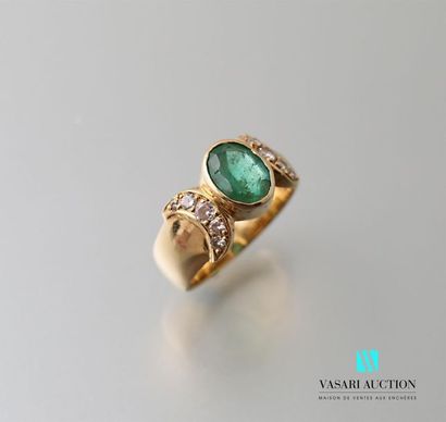 null Yellow gold ring 750 thousandths centred on an oval emerald in closed set with...