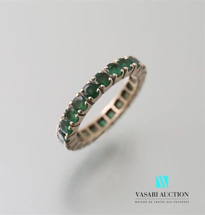 null 750-thousandths white gold wedding ring set with 22 round emeralds Gross 
weight:...