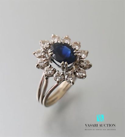 null Ring in 750-thousandths white gold centred on an oval sapphire (1.10 to 1.30...