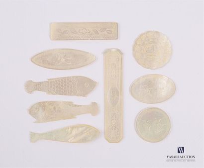 null Set of engraved mother-of-pearl tokens in circular shape, fish, shuttle and...