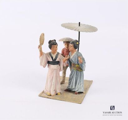 null A polychrome patinated lead subject representing three Geishas under an umbrella...