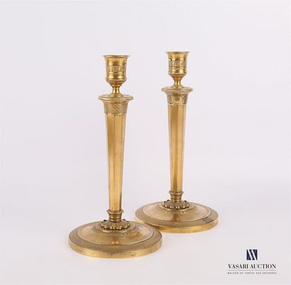 null Pair of golden brass torches resting on a doucine base with a trellis frieze...