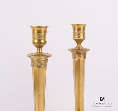 null Pair of golden brass torches resting on a doucine base with a trellis frieze...