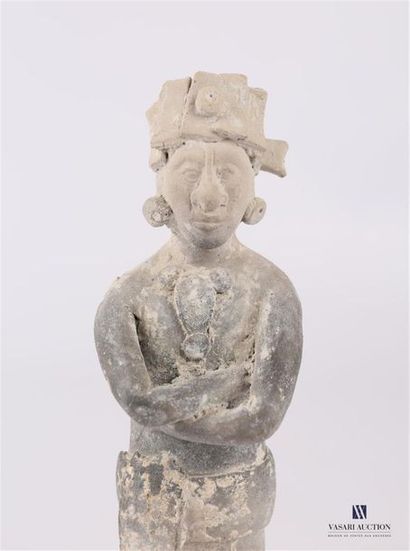 null Sculpture depicting a dignitary standing with his arms crossed.
He is dressed...