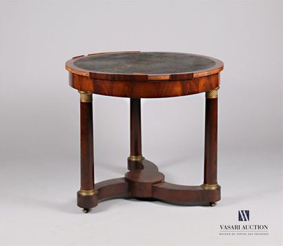 null A mahogany veneered pedestal table, the dark round leather top rests on three...