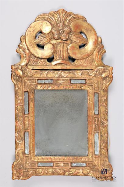 null Mirror with molded and carved wooden glazing beads, it is surmounted by an openwork...