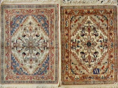 null PAKISTAN
Two wool bedspreads decorated with floral motifs in a beige 
diamond...