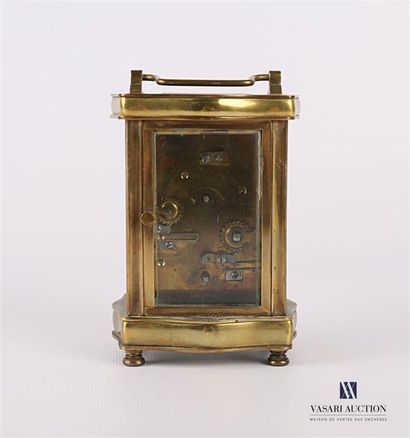 null A gilt bronze and brass travelling clock in the shape of a moving rectangular...