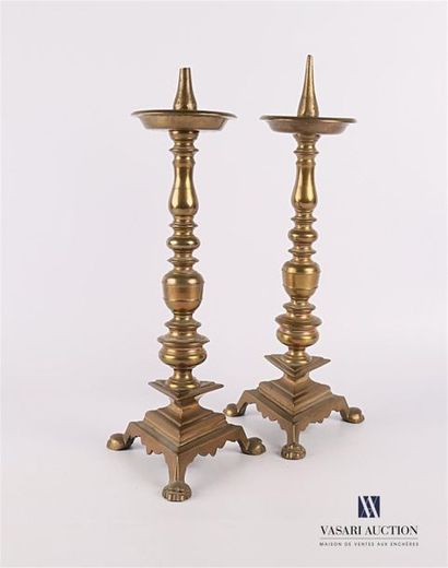 null Pair of bronze candle spikes resting on a triangular base to doucine ended by...