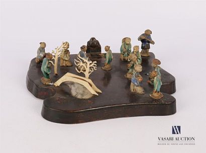 null CHINA
Free-form wooden tray on which twelve enamelled stoneware figures representing...